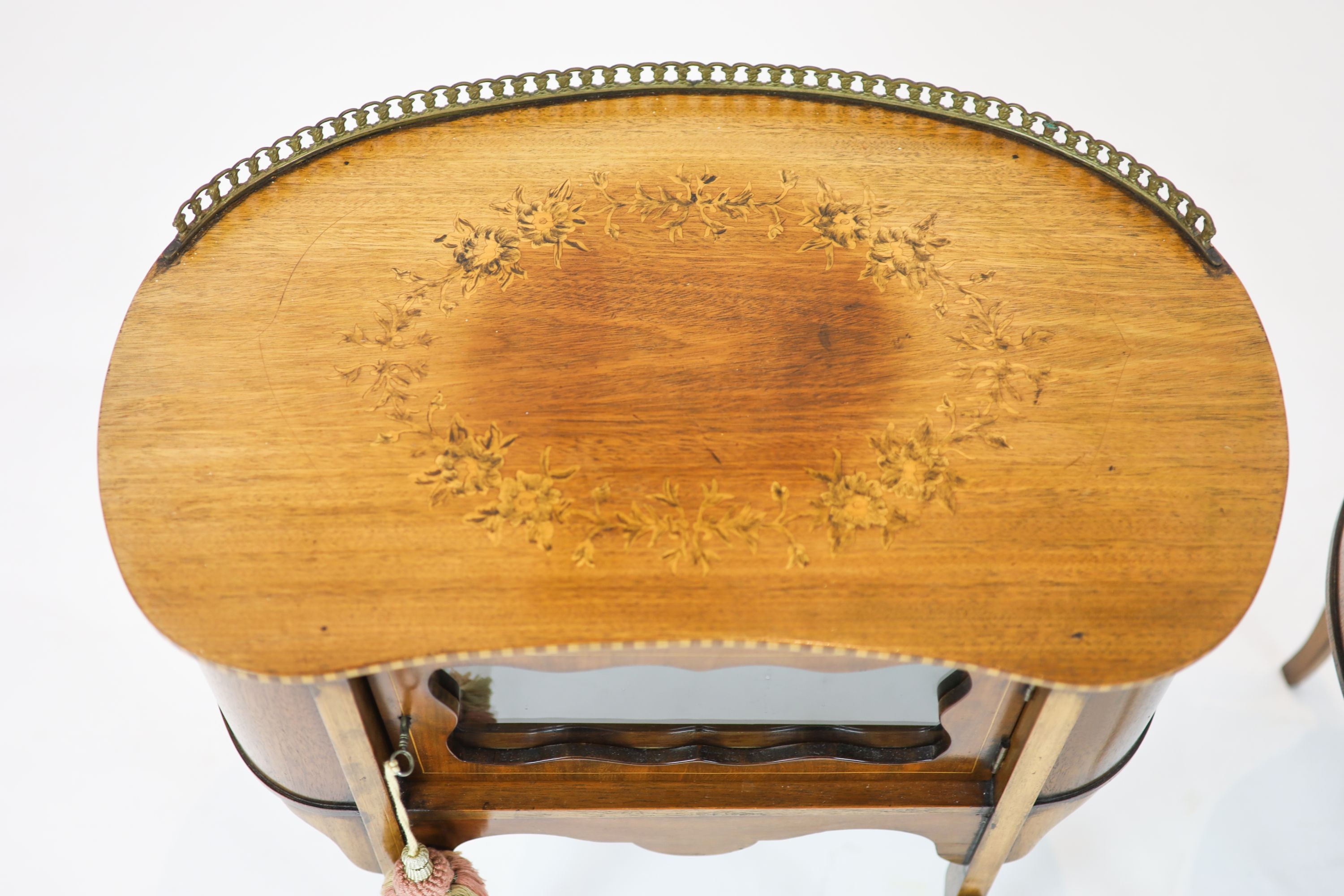 A pair of Edwardian inlaid mahogany kidney shaped side cabinets, each fitted with a central glazed door, raised on cabriole legs, width 60cm, depth 37cm, height 70cm